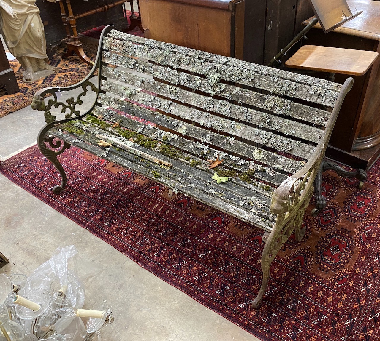 A Victorian slatted wooden garden bench, with pierced cast iron ends, length 128cm, width 60cm, height 78cm